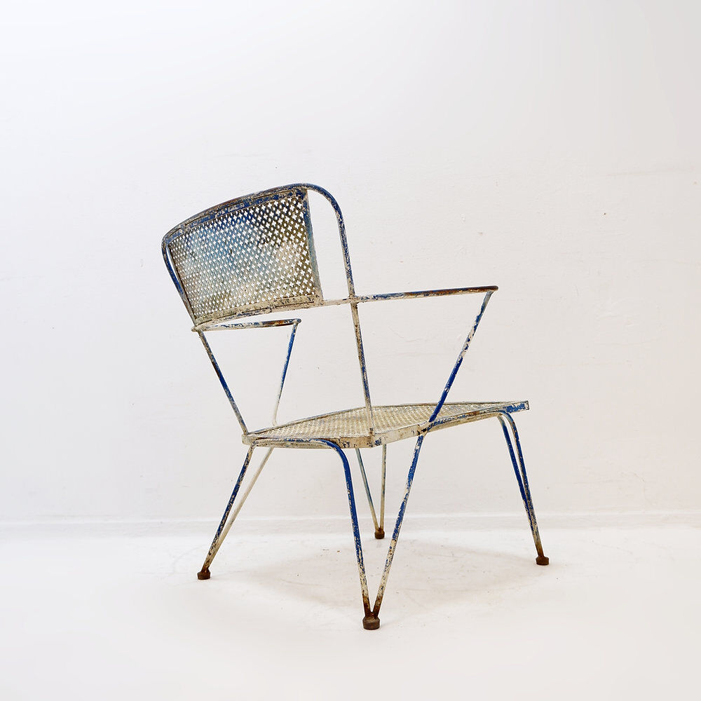 Vintage perforated metal armchair from the 1950s.