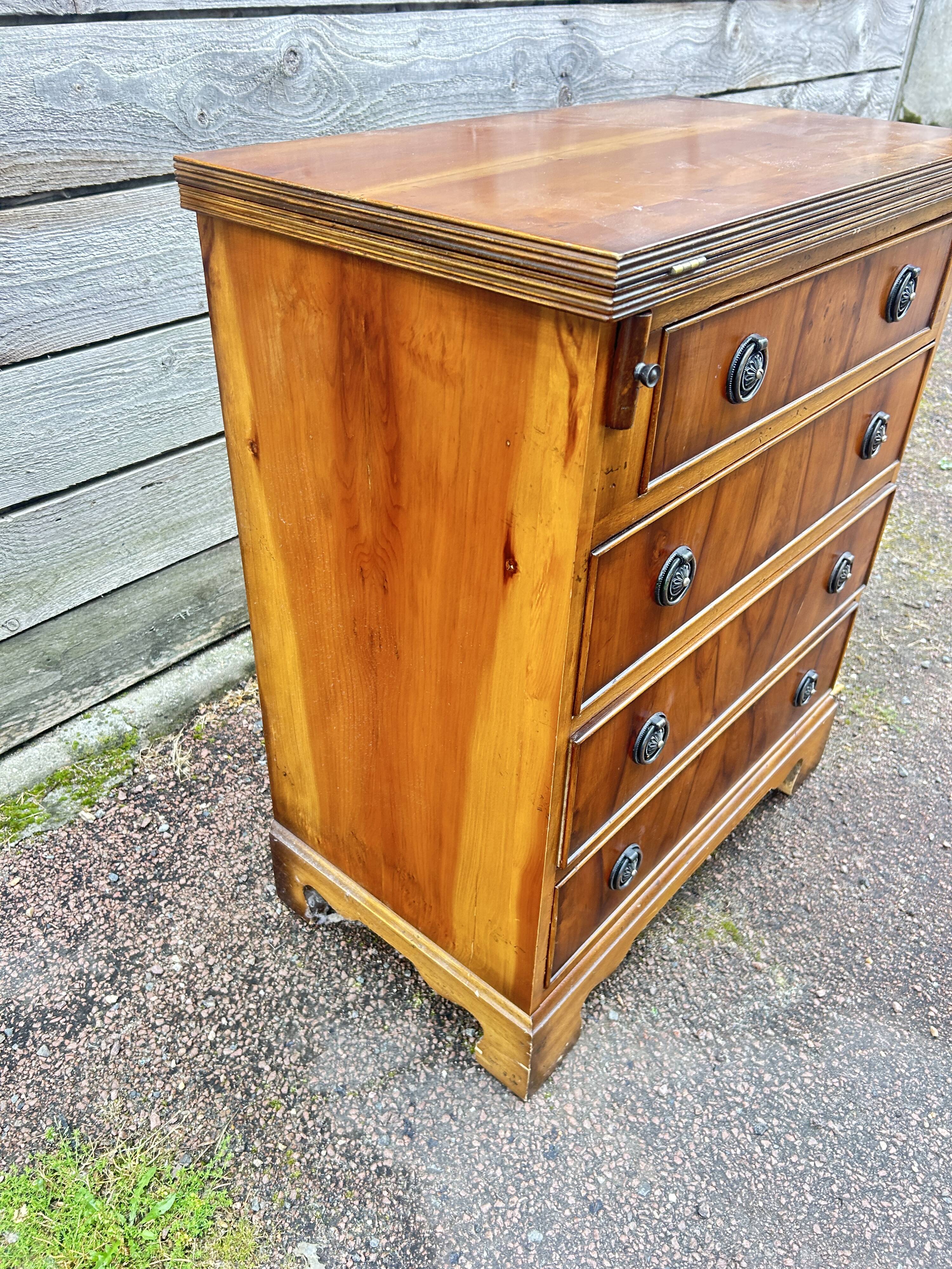 Small English chest of drawers with a folding top.