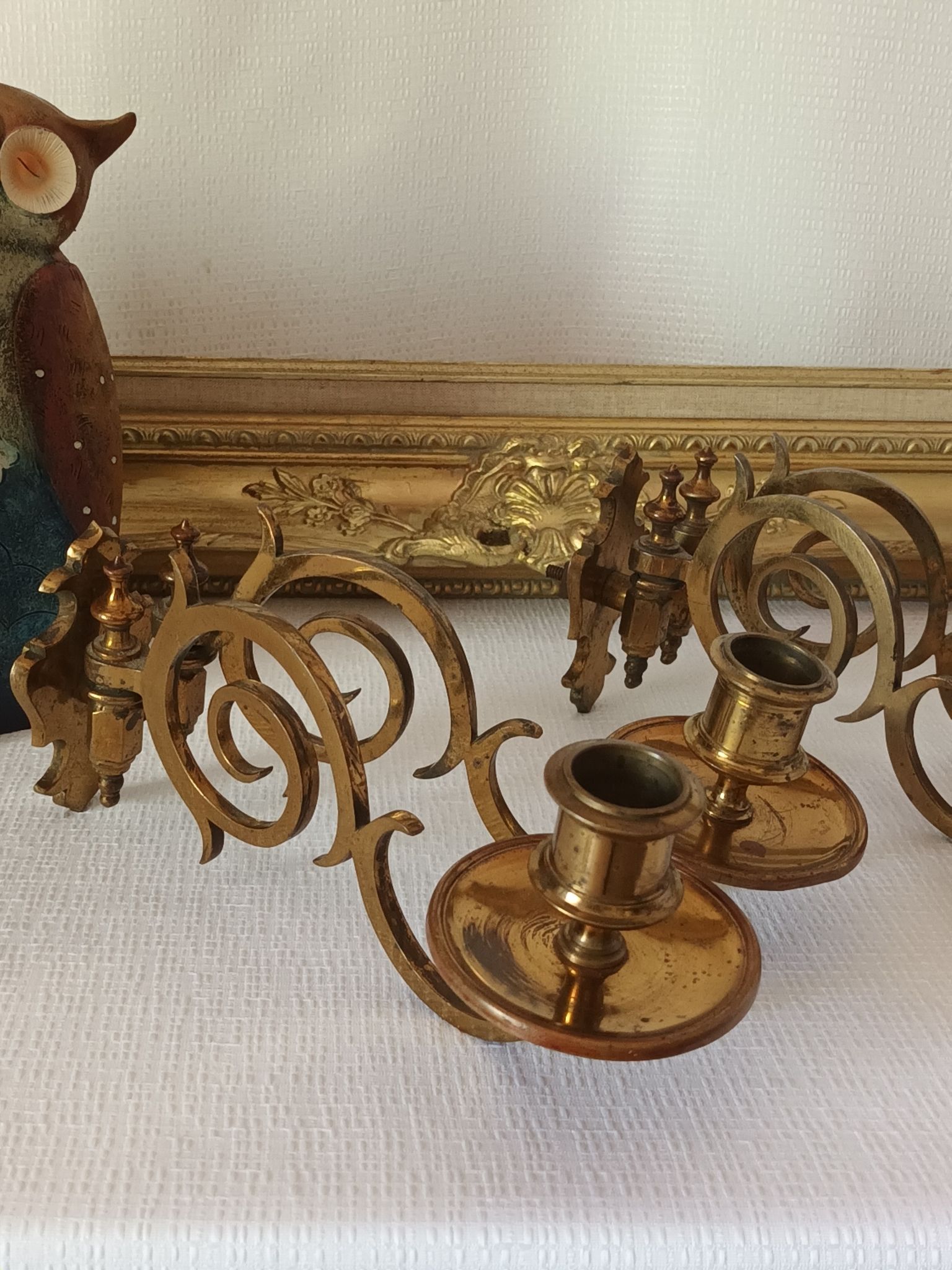 Pair of antique wall-mounted brass candle holders