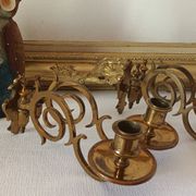 Pair of antique wall-mounted brass candle holders