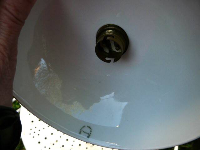 Art Nouveau wall light in bronze with a white Haviland porcelain shade.