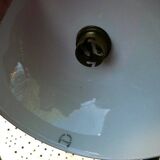 Art Nouveau wall light in bronze with a white Haviland porcelain shade.