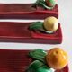 Suite de 6 porte-couteaux barbotine fruits