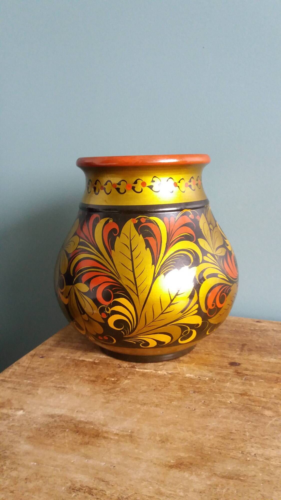 Khokhloma vase, Russian lacquered wood craftsmanship, hand-painted floral decoration.