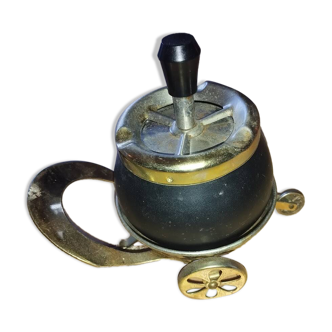 Original vintage ashtray on a small wheeled stand.