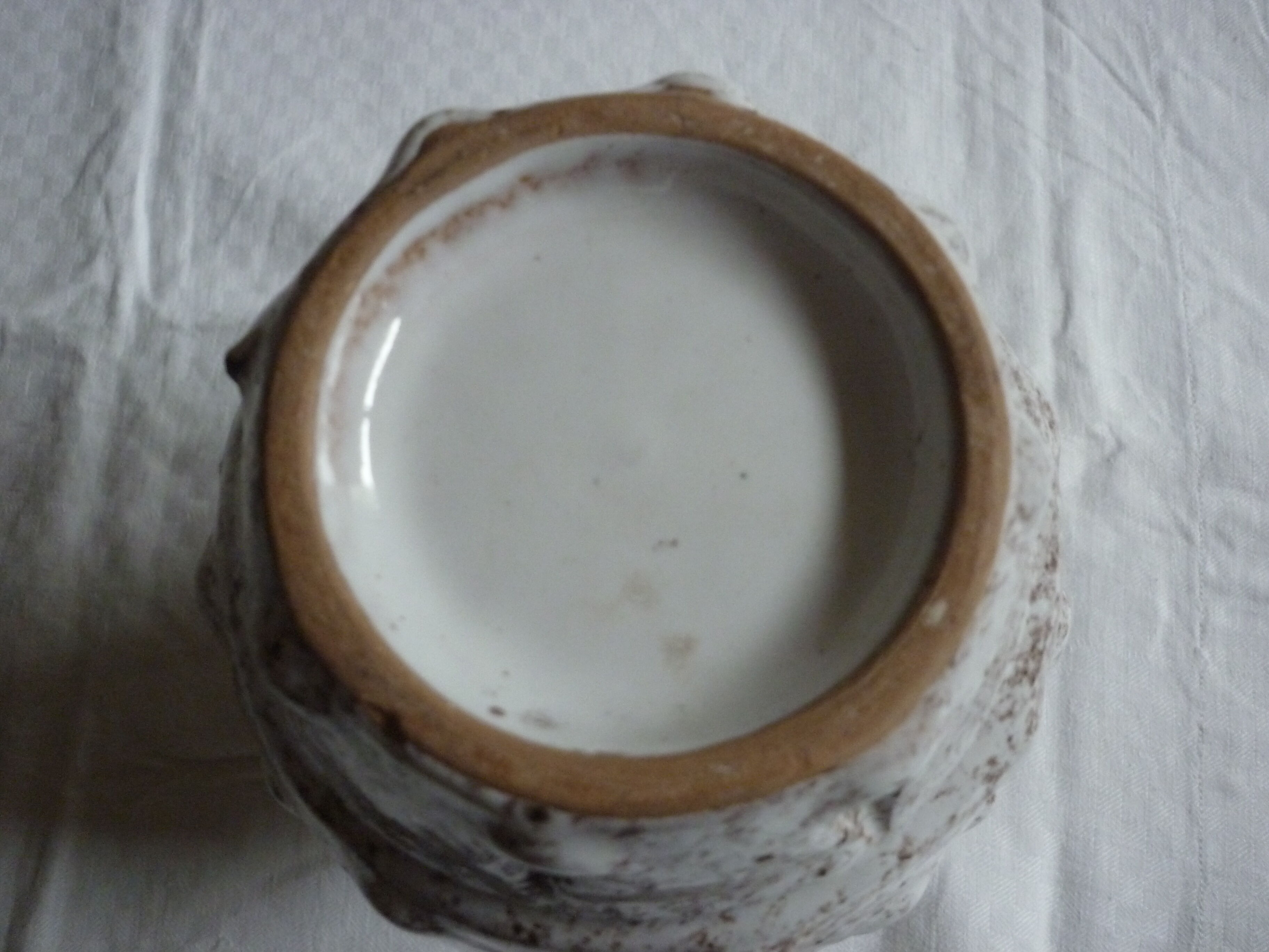 Spotted white ceramic vase with hollow form of tears