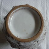 Spotted white ceramic vase with hollow form of tears