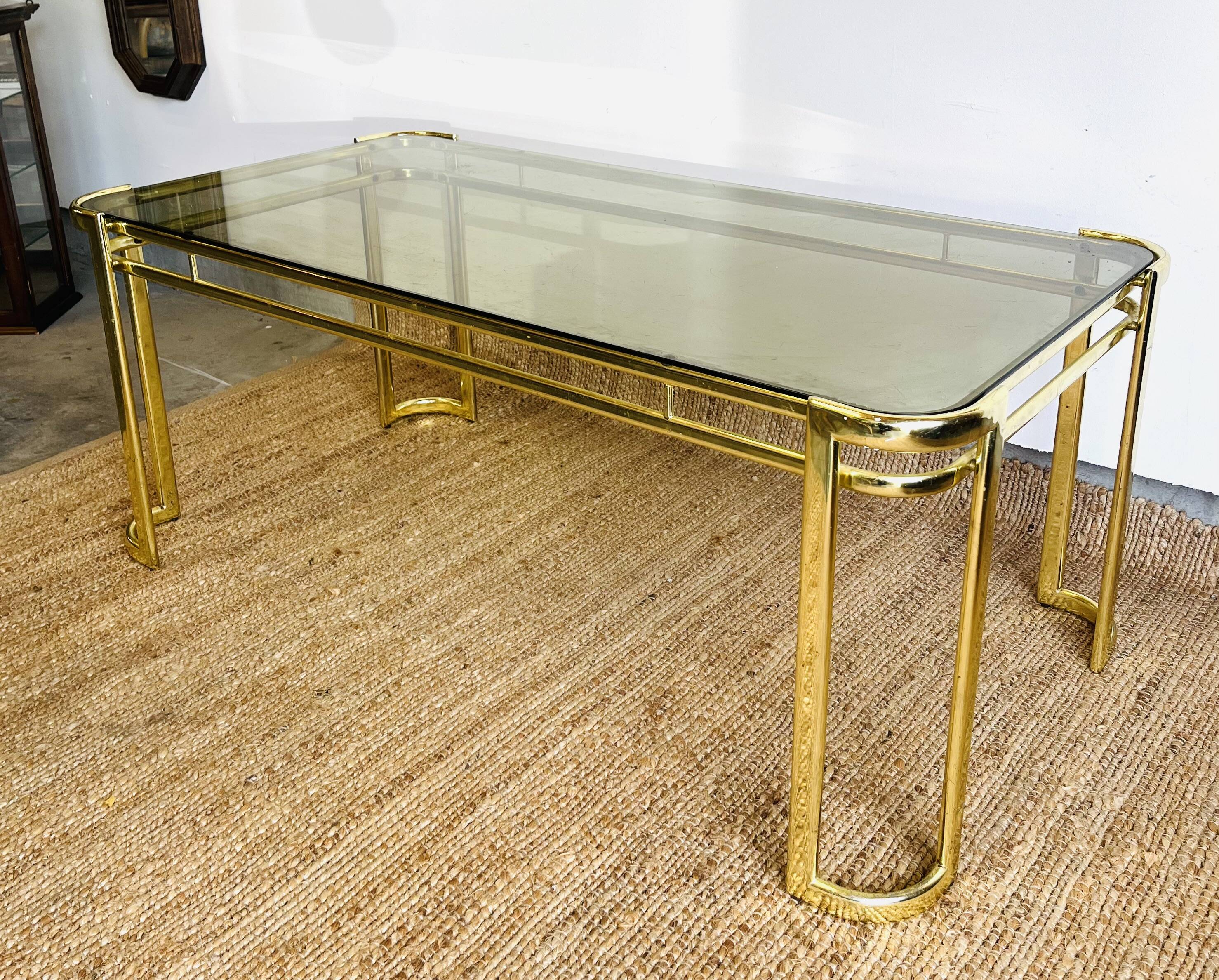 Gold metal and smoked glass coffee table – 1970s-624001