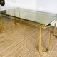 Gold metal and smoked glass coffee table – 1970s-624001