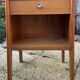 Wooden bedside table, warm tones, vintage, 1950s.