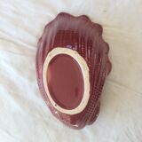 Empty red ceramic snail shaped pouch