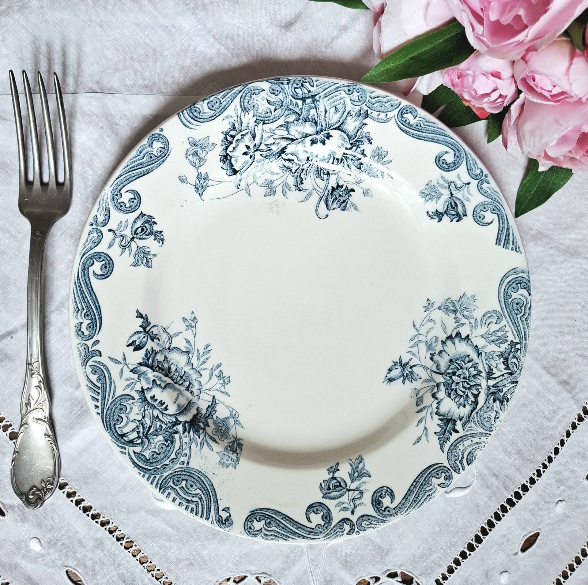 Old mismatched flat plates made of ironstone earthenware.