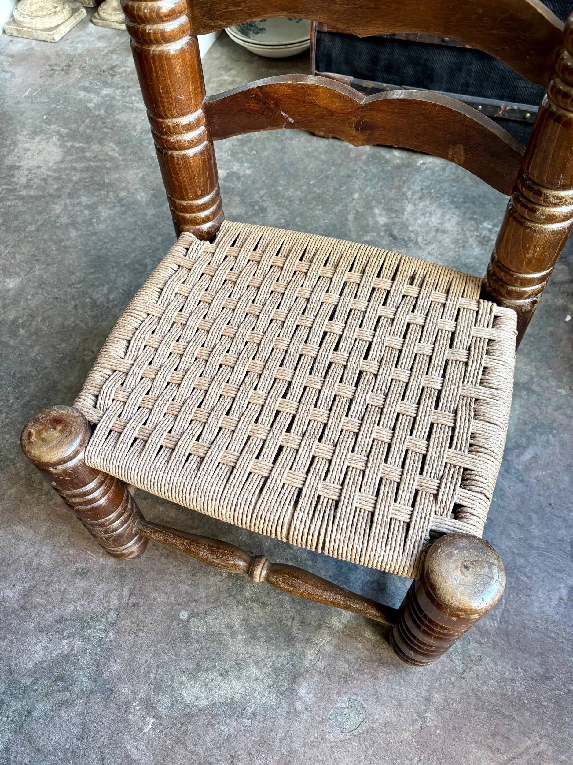 Low chair in dark wood and woven Danish cord attributed to Charles Dudouyt.