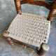 Low chair in dark wood and woven Danish cord attributed to Charles Dudouyt.