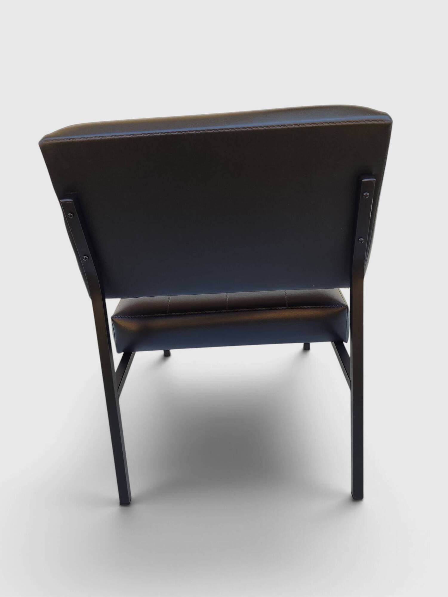 Modernist armchair in black faux leather and metal – 1960s