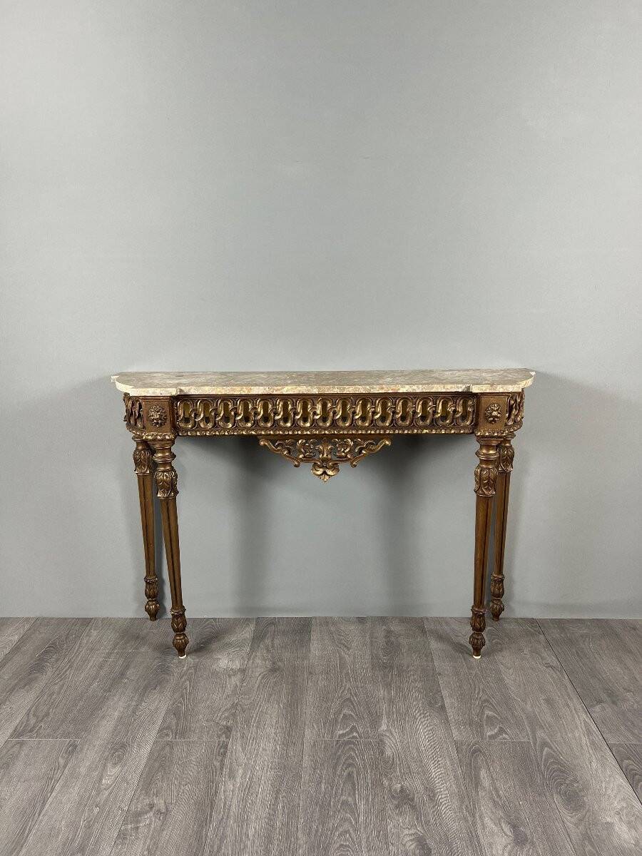 Louis XVI style console in carved wood with a gilded patina, 19th century.