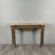 Louis XVI style console in carved wood with a gilded patina, 19th century.