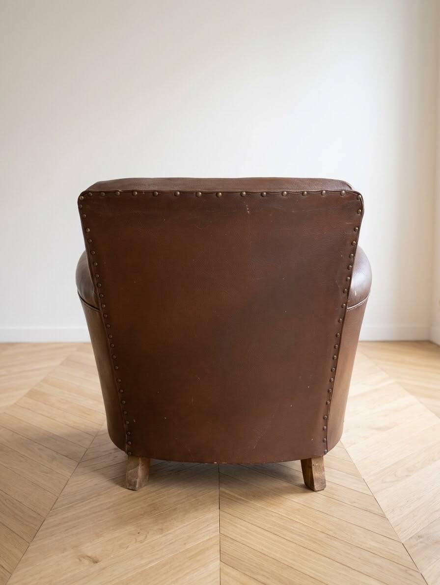 Vintage 1950s armchair in brown faux leather.