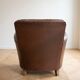 Vintage 1950s armchair in brown faux leather.