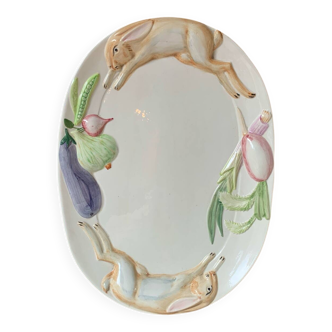 Very large serving dish with hares and vegetables.