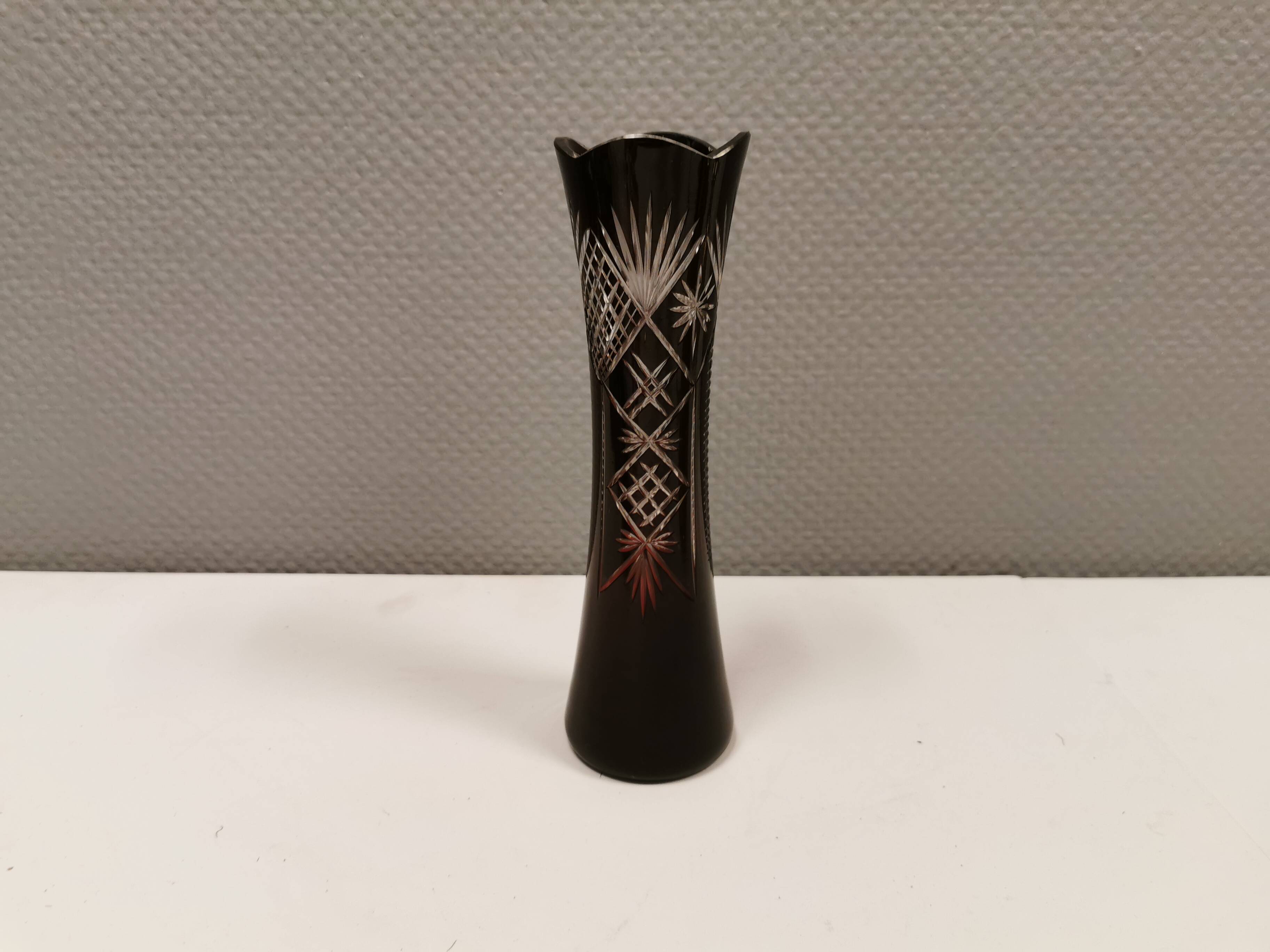 Crystal glass vase, in burgundy/reddish coloured glass with translucent details.