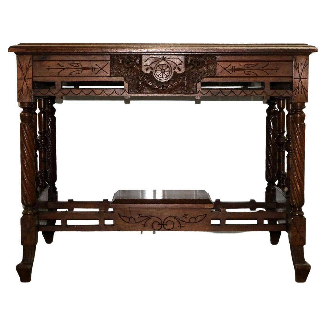 19th-century carved walnut desk with a leather top.