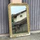 Large Louis Philippe mirror in carved gilded wood with mercury glass.