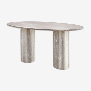 Calypso oval dining table in natural travertine, ribbed legs
