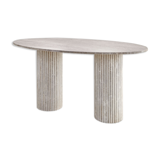 Calypso oval dining table in natural travertine, ribbed legs