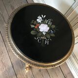 A gilded carved wooden pedestal table with a marble marquetry top