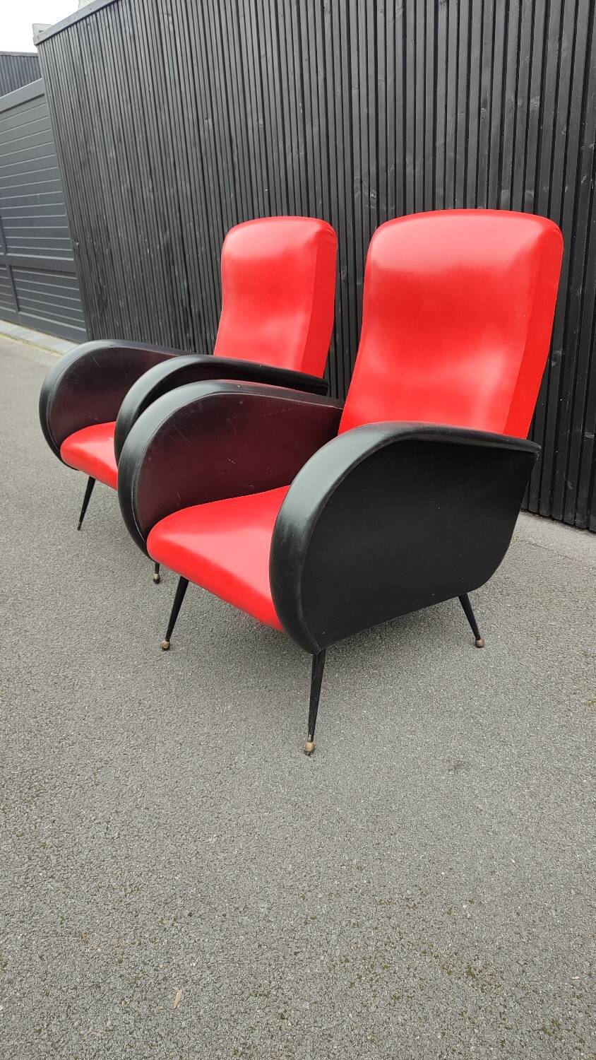 Pair of red and black faux leather armchairs