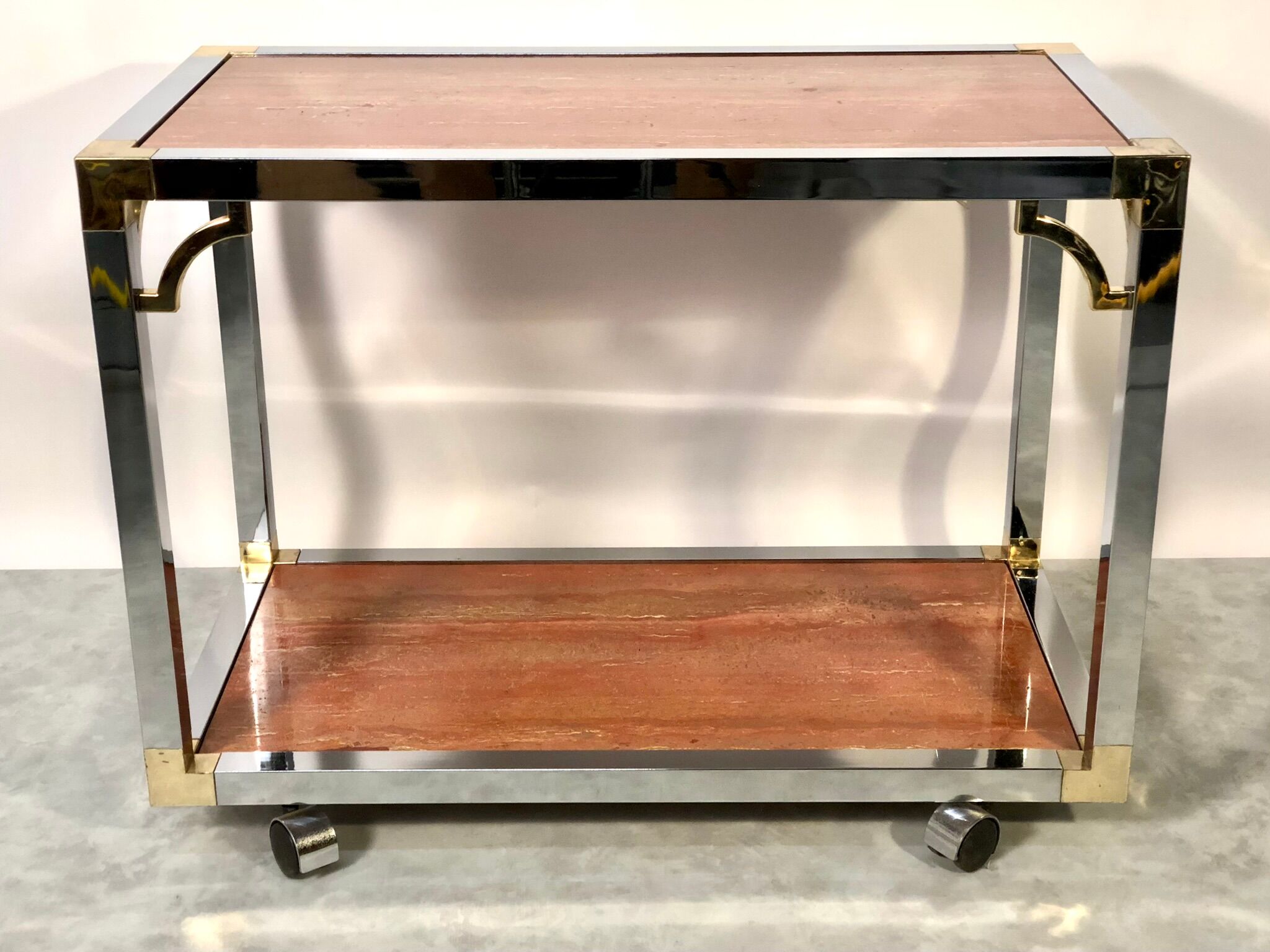 Italian rolling dessert table with two trays decorated with pink travertine