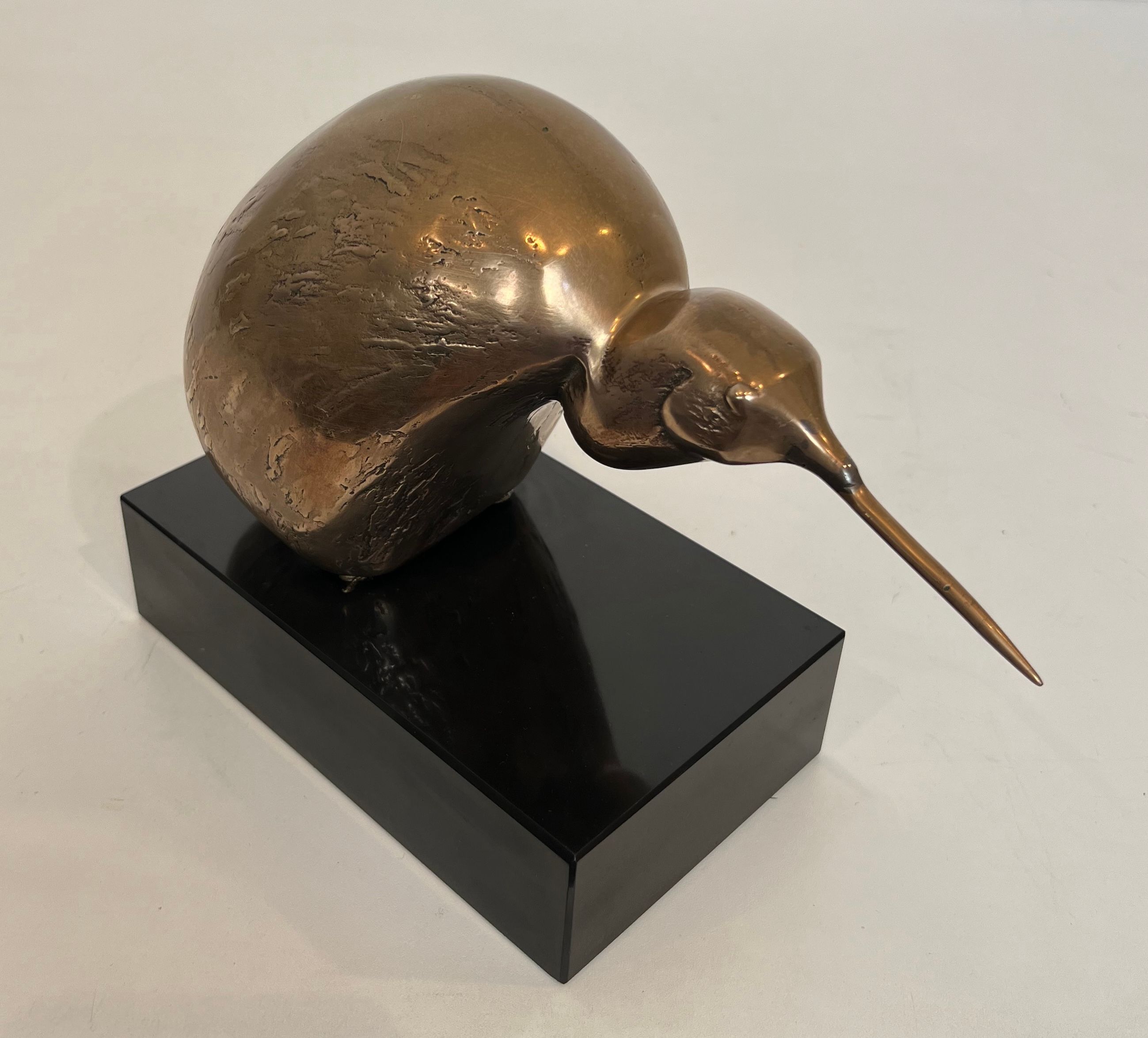 Bronze sculpture representing a stylised bird on a black marble base, signed and numbered.