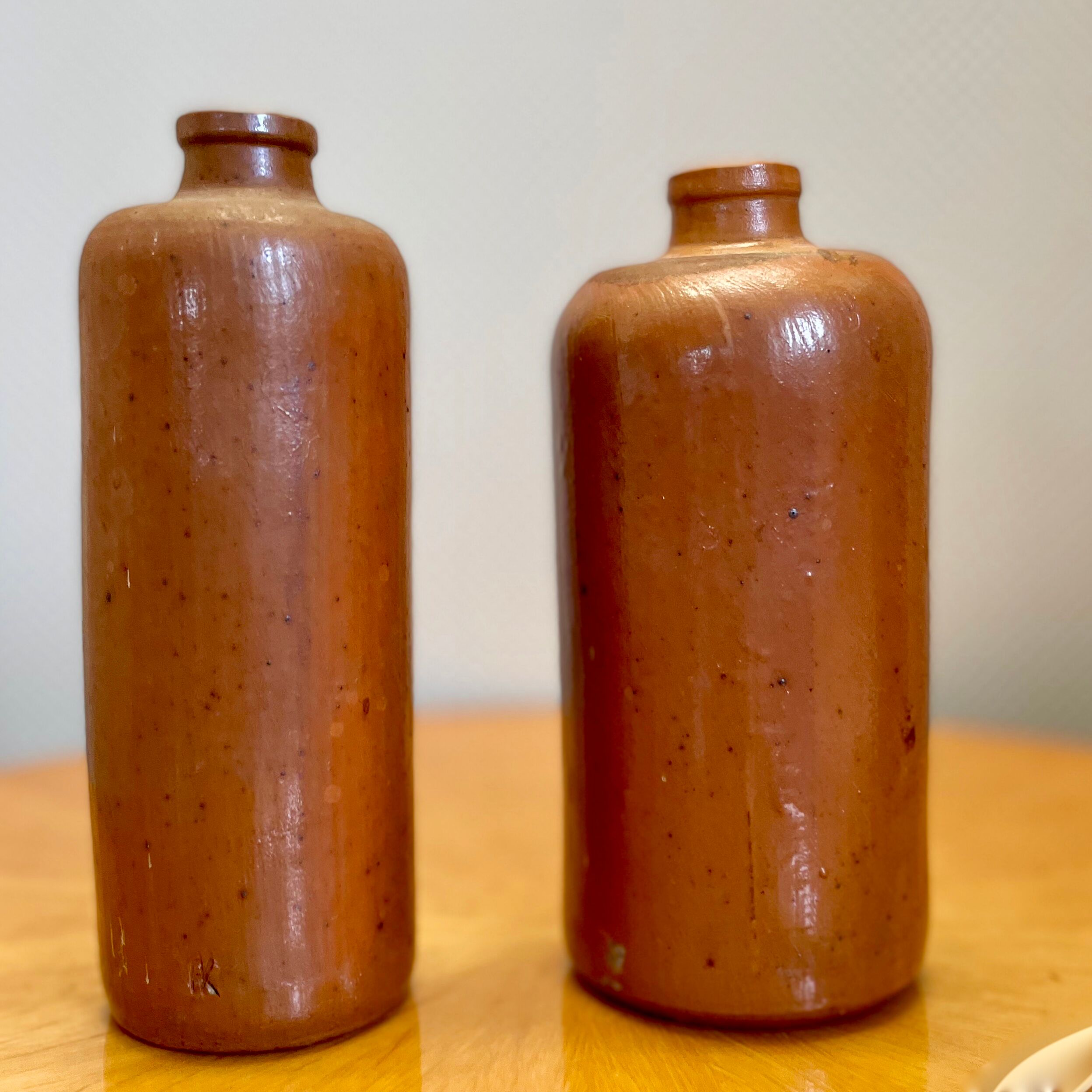 Set of two bottles or jugs in ocher-brown enamelled sandstone