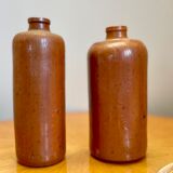 Set of two bottles or jugs in ocher-brown enamelled sandstone