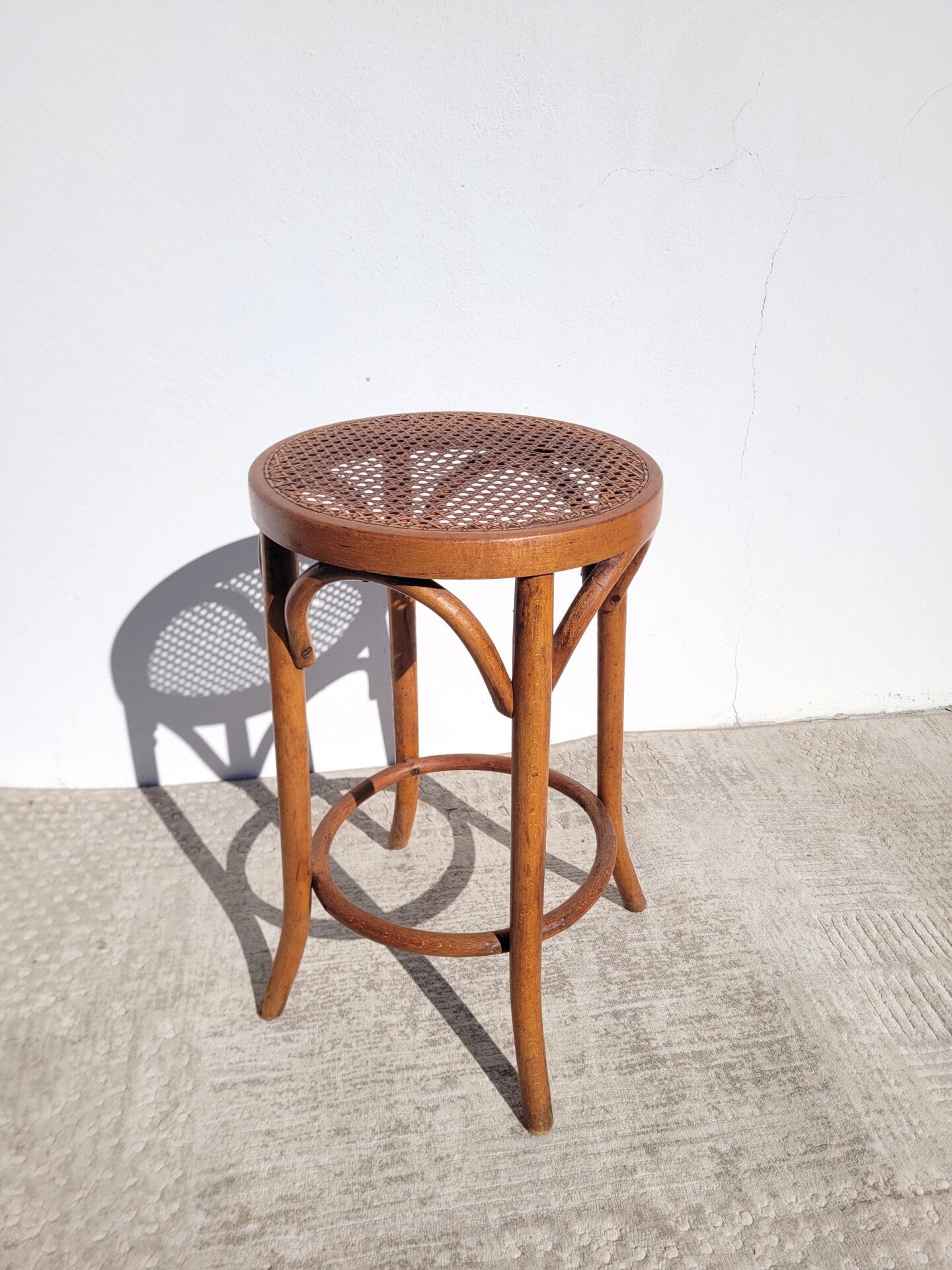 Old low caned bistro stool