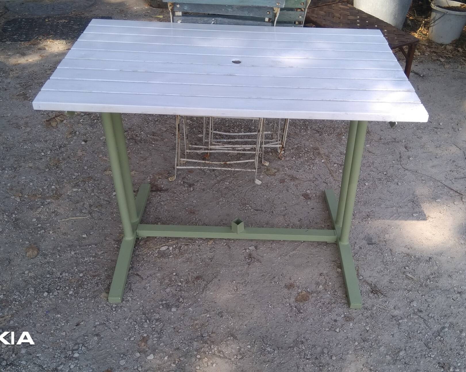 Old garden table with iron slats