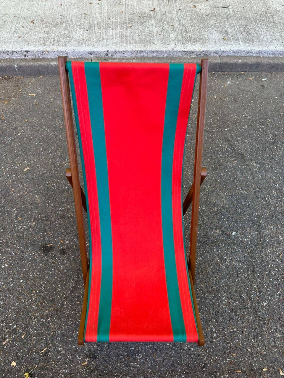 Vintage folding wooden deck chair with red and green striped canvas from the 1970s.