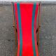 Vintage folding wooden deck chair with red and green striped canvas from the 1970s.