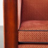 Art Deco design armchair with red fabric upholstery and wooden details