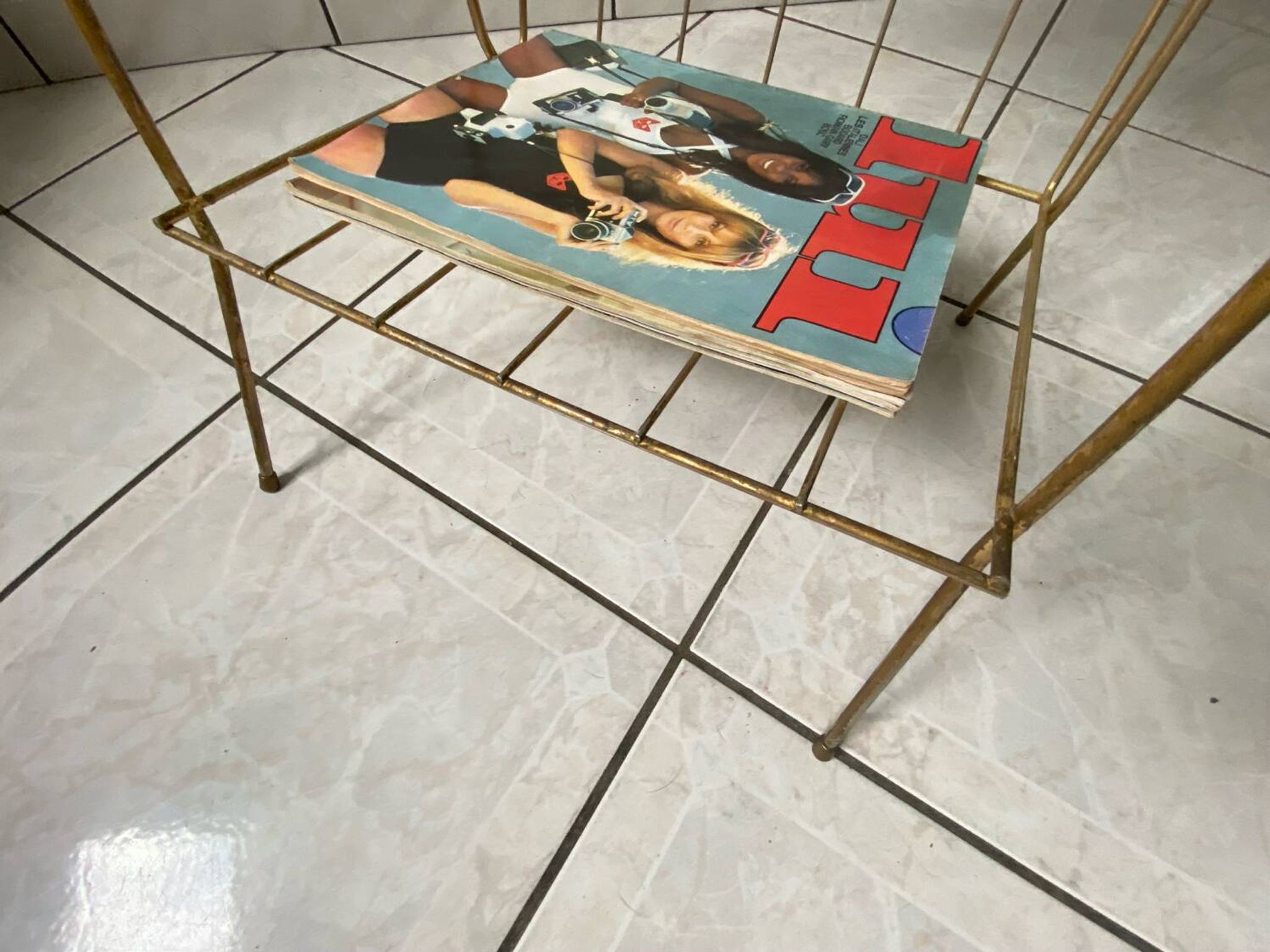 Vintage 1960s brass and smoked glass side table with magazine holder.