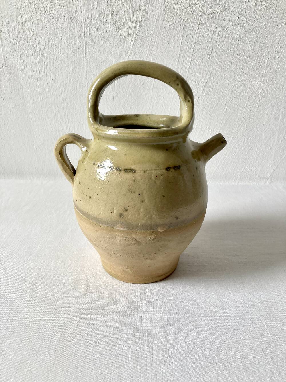 Old small goat-shaped jug in ochre glazed stoneware.