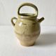Old small goat-shaped jug in ochre glazed stoneware.