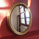 Golden oval mirror