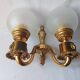 Wall lamp in gilded bronze with a lion's head and engraved globe.