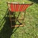 vintage wooden deck chair with striped fabric and footrest