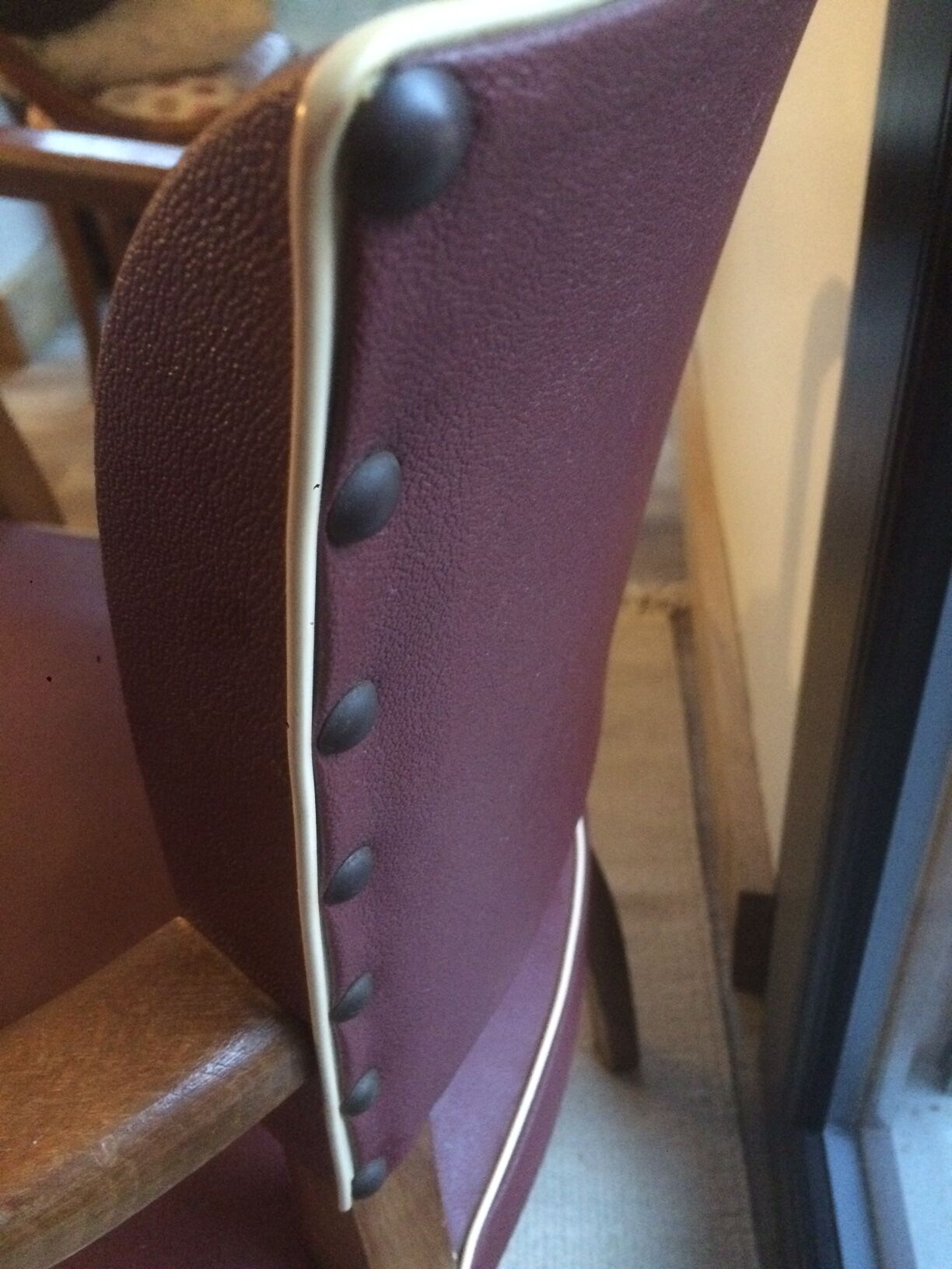 Skai chair binds wine and wooden footpieces and armrests