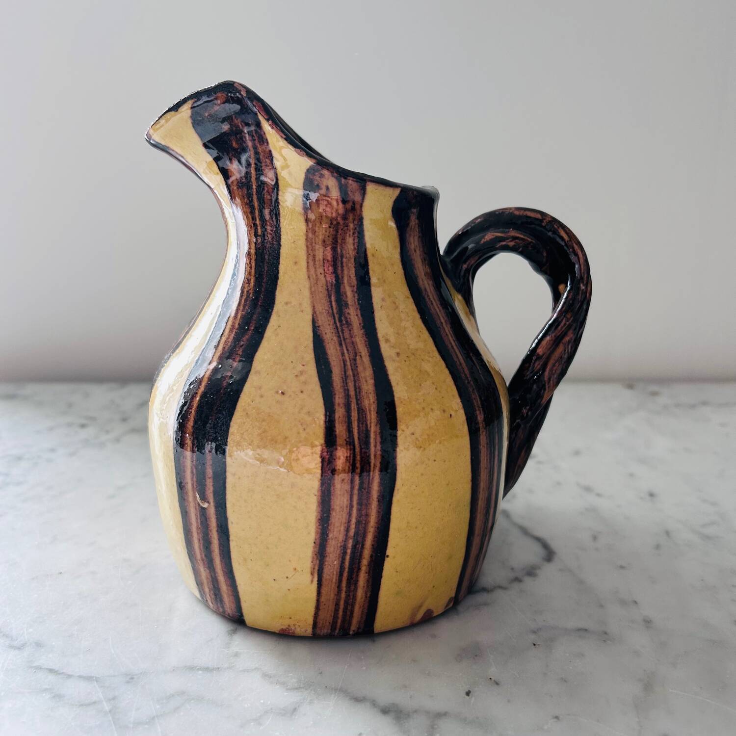 Striped decorative pitcher signed