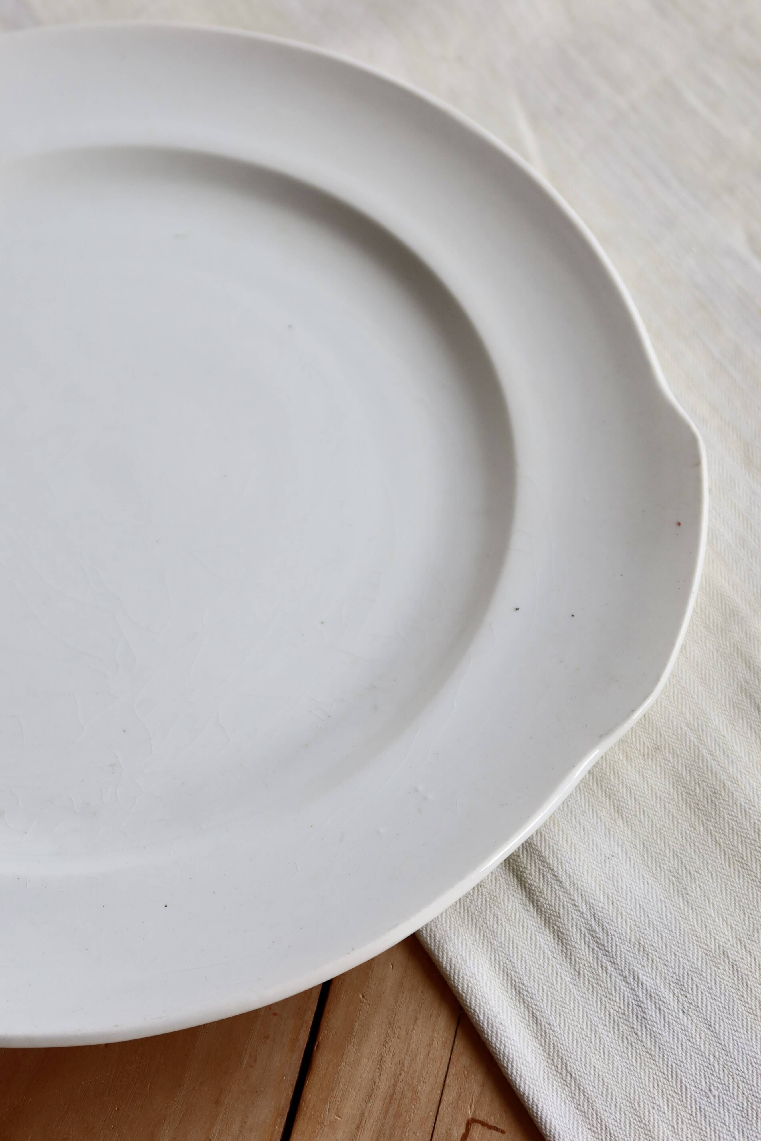 Vintage round white porcelain serving dish with handles.