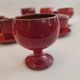 Red enamelled terracotta: cups, saucers, glasses